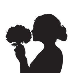 Bride smelling bouquet of flowers